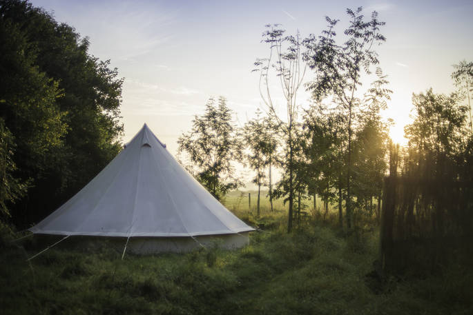 Watch the sunrise from your tent at The Farm Camp in Wiltshire
