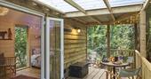 cosy woodland cabin hot tub buckinghamshire glamping covered outside terrace