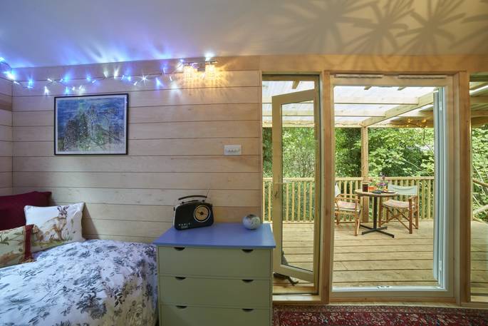 cosy cabin with hot tub woodland bedroom with door to covered decking