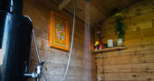 The wooden clad shower hut at Mill Valley Farm in Cornwall