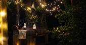 Hot tub surrounded by fairy lights for a relaxing stay