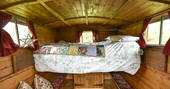 Cosy double pull out bed at Evelyn Wagon, Drybeck Farm, Cumbria