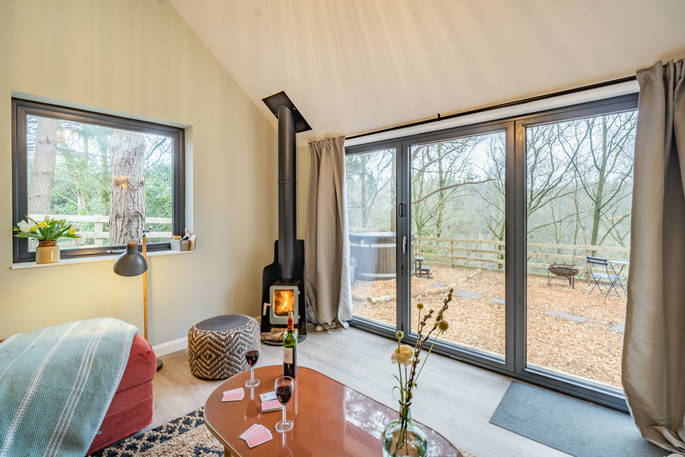 Forrest, The Lost Cabins - living room with wood burner and view, Edenhall Estate, Penrith, Cumbria