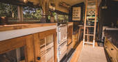 Fully equipped kitchen inside the converted bus at Hinterlandes in a remote corner of The Lake District