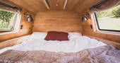 One double bed inside Hinterlandes the converted bus in a remote corner of The Lake District 
