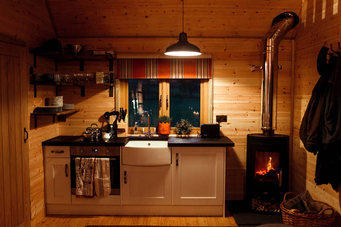 netherby treehouse cumbria england uk glamping tree house holiday kitchen and woodburner 