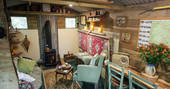 Cosy up by the wood-burner inside the shepherd's hut at Turners Woodland Suite at Acorn Farm in Devon
