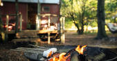 Toast marshmallows and enjoy them whilst sitting round the outdoor fire pit at Turners Woodland Suite in Devon
