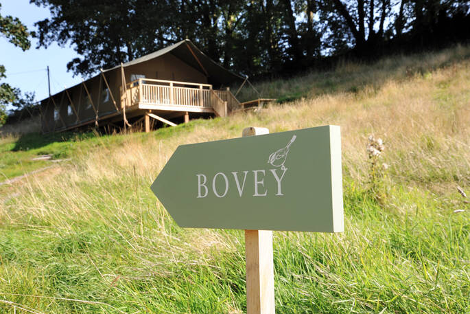 Brownscombe Luxury Glamping in Devon with Bovey sign outside safari tent for six 