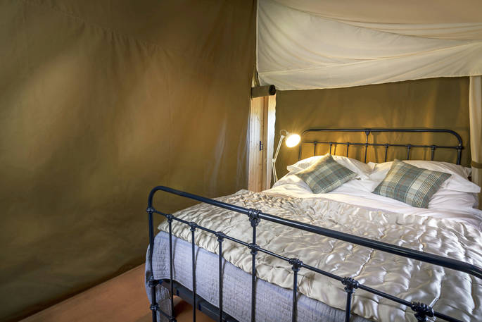 Comfy king-size bed in Bovey safari tent in Devon