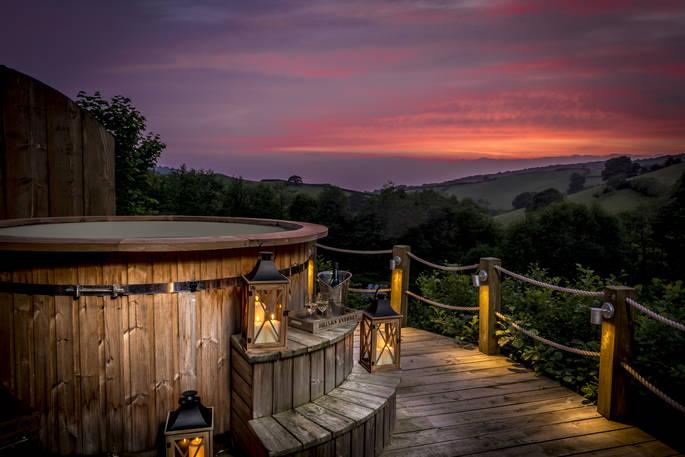 Hot tub with sunset view at Longlands safari tents at Combe Martin, North Devon