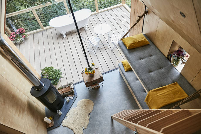 Living space area shown from the perspective of the mezzanine level at Cleave Treehouse in Devon