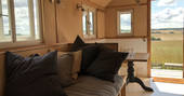 Lounging area inside of Murgatroyd with views of the fields of Dorset from the front door
