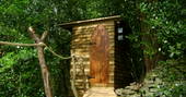 Sapperton Yurt wood cabin housing compost toilet hidden in the trees