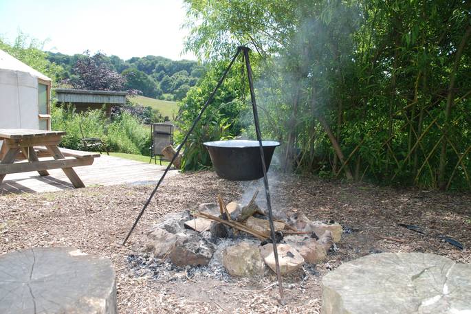 Cook a delicious meal on the firepit and dine al fresco at Cider Orchard Yurt in Gloucestershire