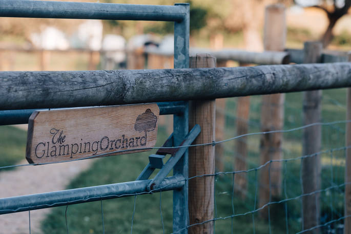 belle the glamping orchard sign