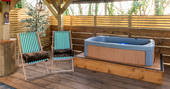 Hot tub on the decking next to Bluebell the shepherd's hut at The Wright Retreat in Gloucestershire