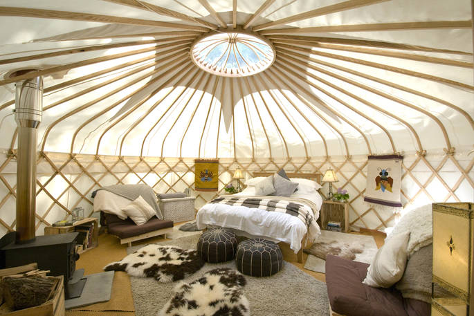 Sapperton 18ft yurt view of interior space with bed and wood-burner