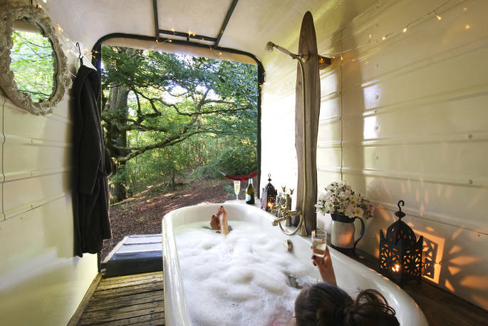 Sit in the bath with a glass of bubbly and endless views of the woodland at Sapperton Yurt in Gloucestershire