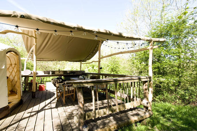 Outdoor sheltered decking for cooking and dining outside Yurt Reynolds at Westley Farm in Gloucestershire 