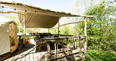 Outdoor sheltered decking for cooking and dining outside Yurt Reynolds at Westley Farm in Gloucestershire 