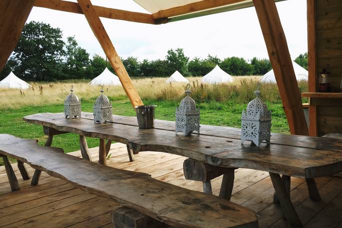 Dine al fresco and sit on the wooden benches in the communal areas at Munday’s Meadow at Wild Wood Bluebell