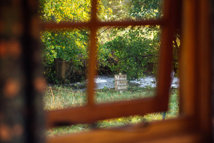 Millie the Hut shepherd's hut view from the inside to the river, Wegnalls Mill, Presteigne, Herefordshire - Owen Howells Photography