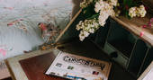 The Canopy and Stars post sits upon the vintage bedside table adorned with flowers
