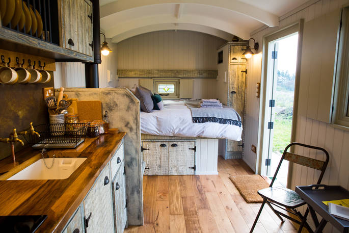 King-size bed inside of Ted the shepherd's hut at Tin and Wood in Leicestershire