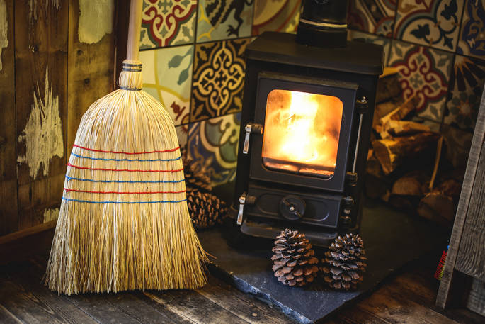 Roaring woodburner with decorative tiles inside Rowan Cabin in Northumberland 