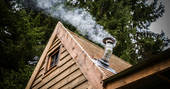 Smoking chimney at Rowan wilderness cabin in Northumberland 