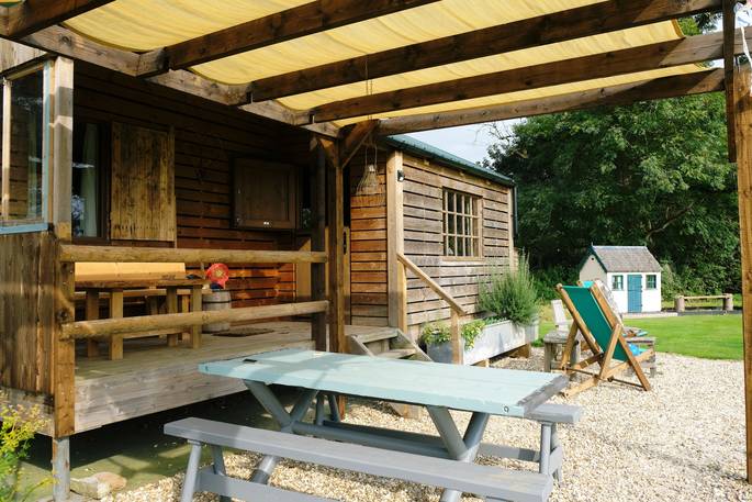 Coach House Cabin glamping - outside decking eating picnic table, Castle Cary, Somerset