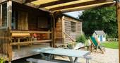 Coach House Cabin glamping - outside decking eating picnic table, Castle Cary, Somerset