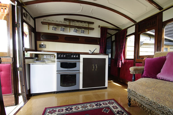 Fully equipped kitchen inside The Victorian Railway Carriage at Coppins Farm in Suffolk  