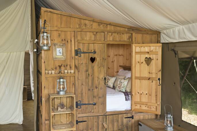 Luxury Lodge Tent 031 2022 Cupboard Bed by Chris Rawlings - cropped