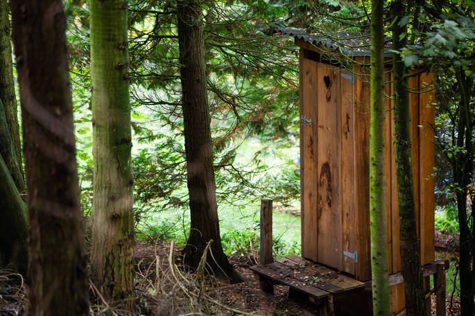 Exterior of the compost loo on ground level at Puckshipton Tree house in Wiltshire 