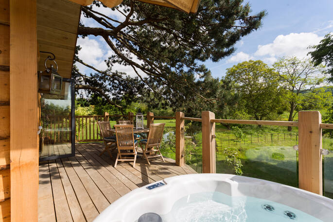 Treetop balcony featuring private hot tub