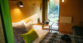 A view of the cosy interiors of Derwen Den at One Cat Farm in Ceredigion, Wales