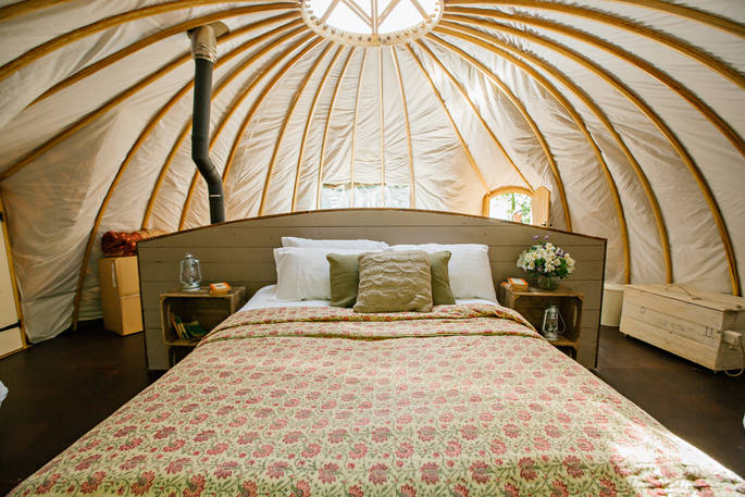 The comfortable kingsize bed inside The Slades tent at Penhein Glamping in Monmouthshire