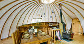 Fully-equipped kitchen and dining area inside The Slades tent at Penhein Glamping in Monmouthshire