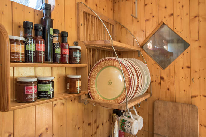 Kitchen with plate rack and selection of local condiments and preserves