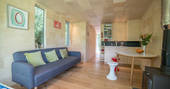 Sofa and fully equipped kitchen inside Beudy Banc Treehouse in Powys