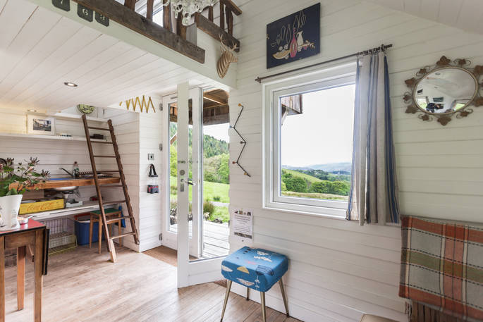 Wooden cabin interior with hill views
