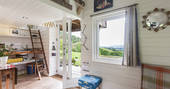 Wooden cabin interior with hill views