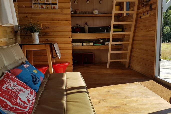 caban cadno cosy cabin powys wales living space kitchen and ladder to access loft bedroom