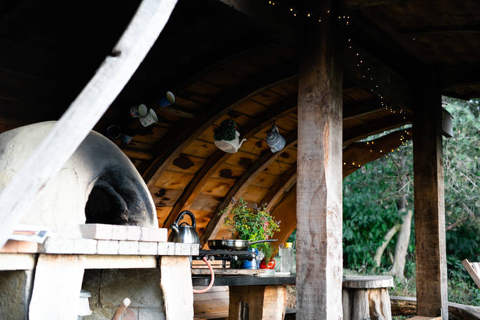 Cook up a feast of local produce in the rustic outdoor kitchen with its own pizza oven at The Sleepout, Sunnylea