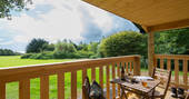 Relax on the decking of Walden Lodge and enjoy the view at Hide at St Donats 