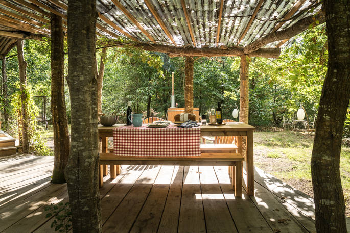 Sit under the covered wood canopy at Elvensong in Dordogne, France