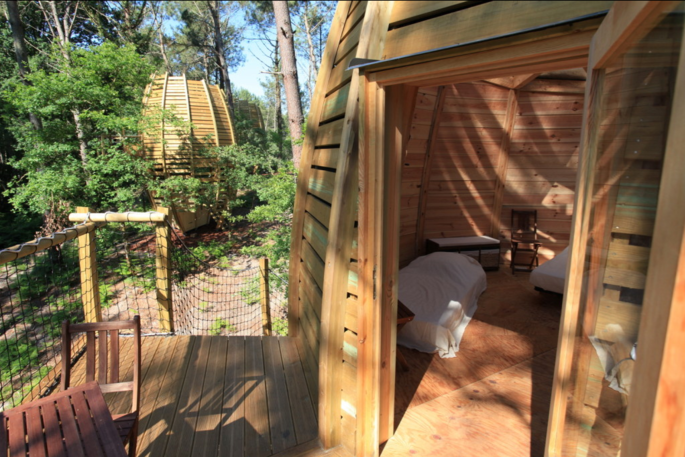 Looking inside the bedroom area from the balcony at River Treehouse, Cap Cabane, Gironde, France