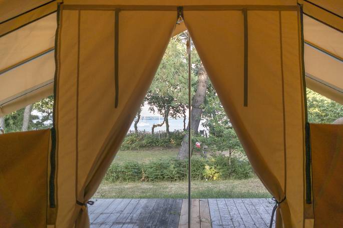Opening doors to Bananec Lodge Tent at Bot-Conan Lodge in France
